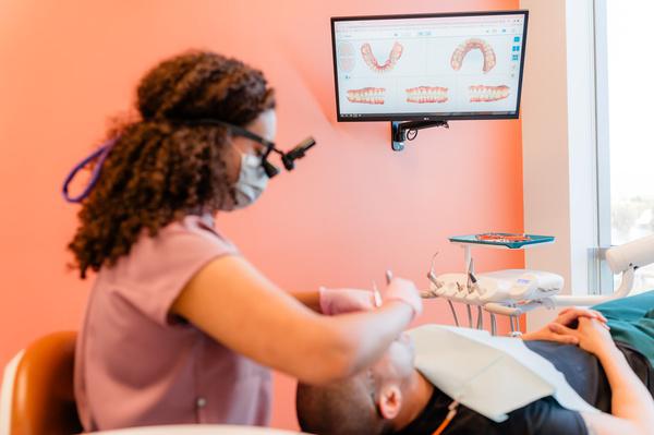 Joanna Jefferson, DDS assisting a patient in Irvine, CA